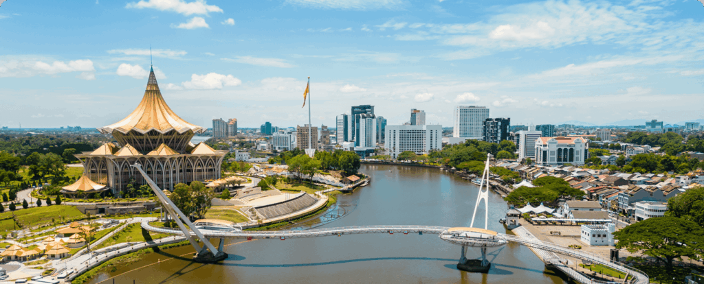 Aerial view of Kuching city with the Sarawak State Legislative Assembly and waterfront.